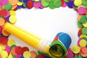 Party blower and  colorful confetti on white background - carnival frame